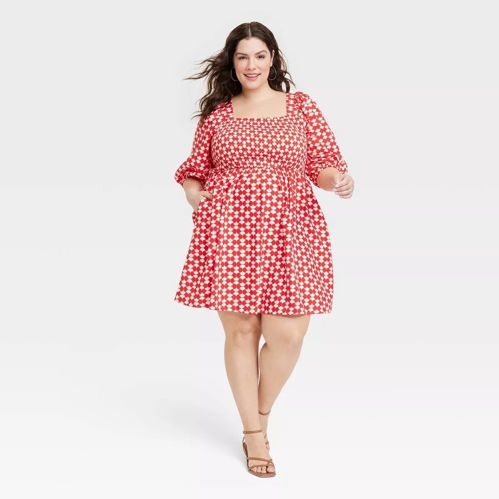 model wearing the dress in red and white checkers
