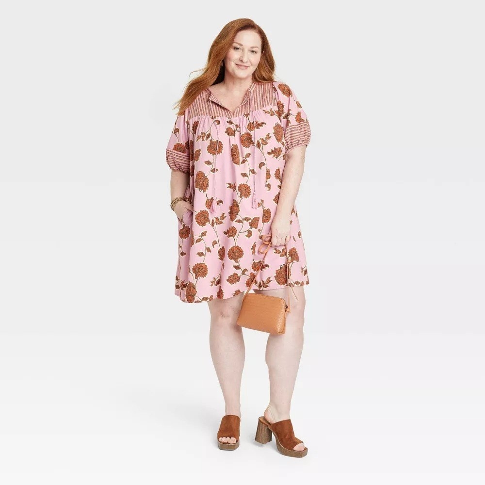 A model in the pink and ochre floral dress