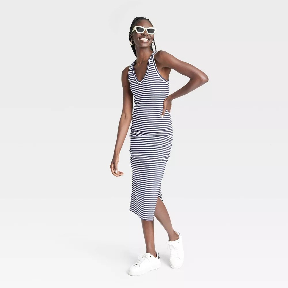A model in the white and blue striped midi dress