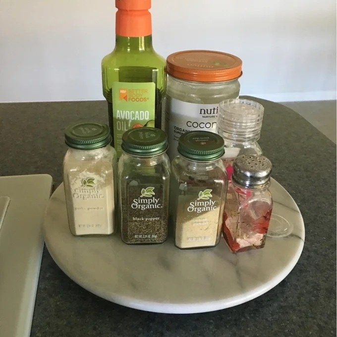 Reviewer image of marble lazy Susan with various seasonings on it