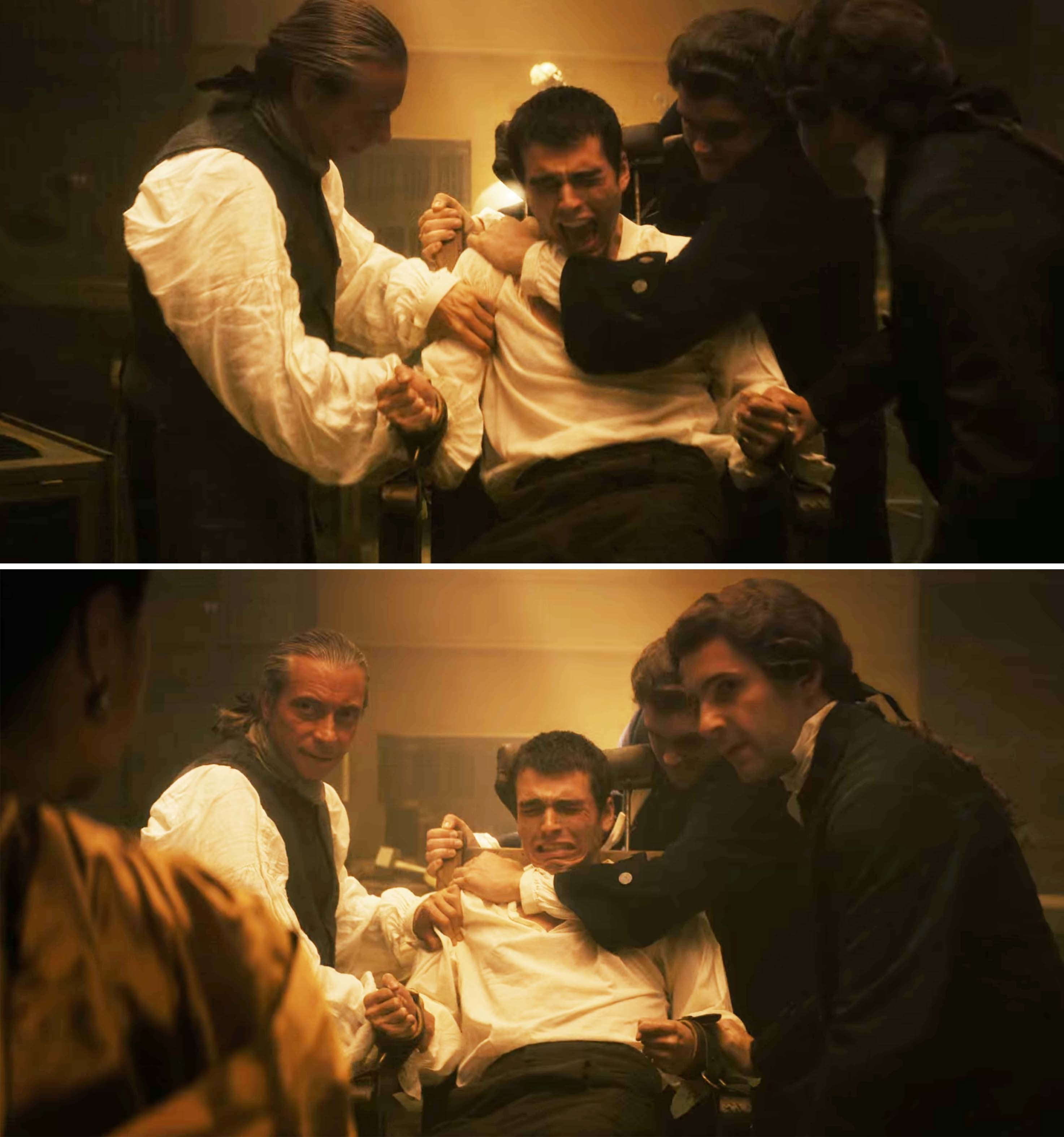 george behing held down by a group of men