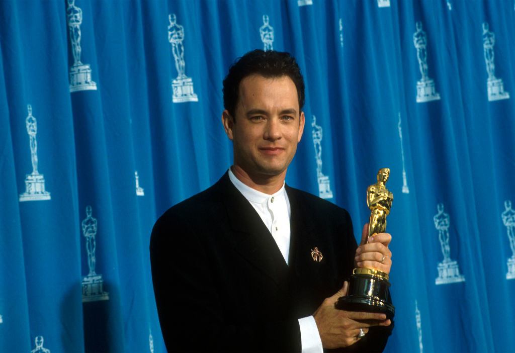Tom Hanks holding his Oscar