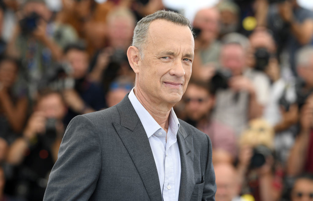 Closeup of Tom Hanks with paparazzi in the background