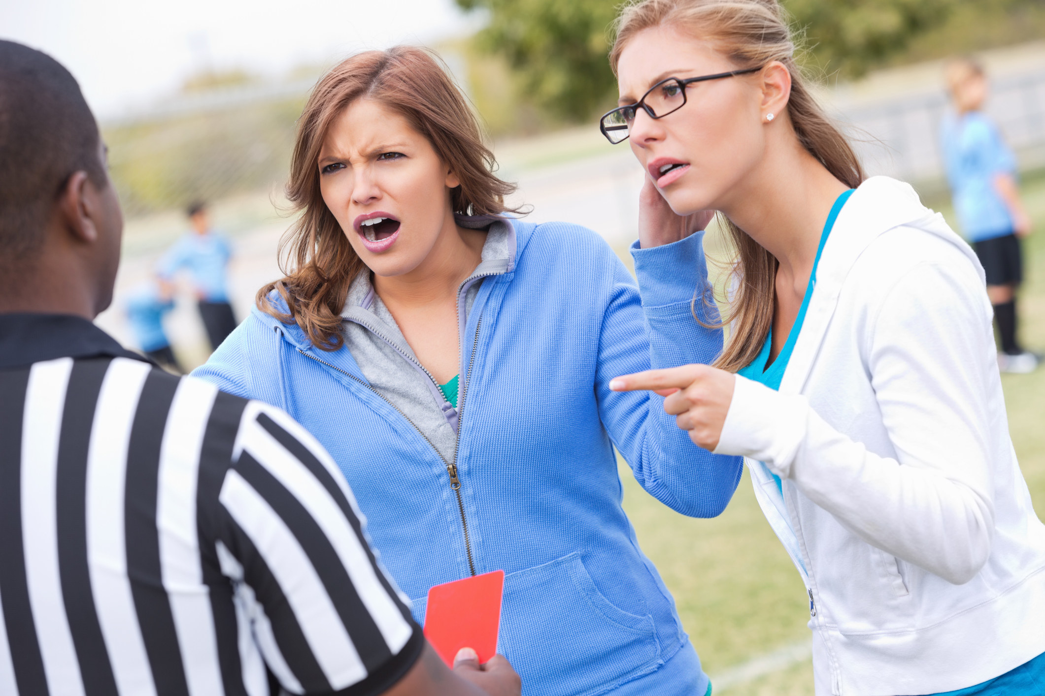 Two moms yelling at a referee