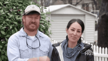 chip and joanna gaines fist bumping each other happily
