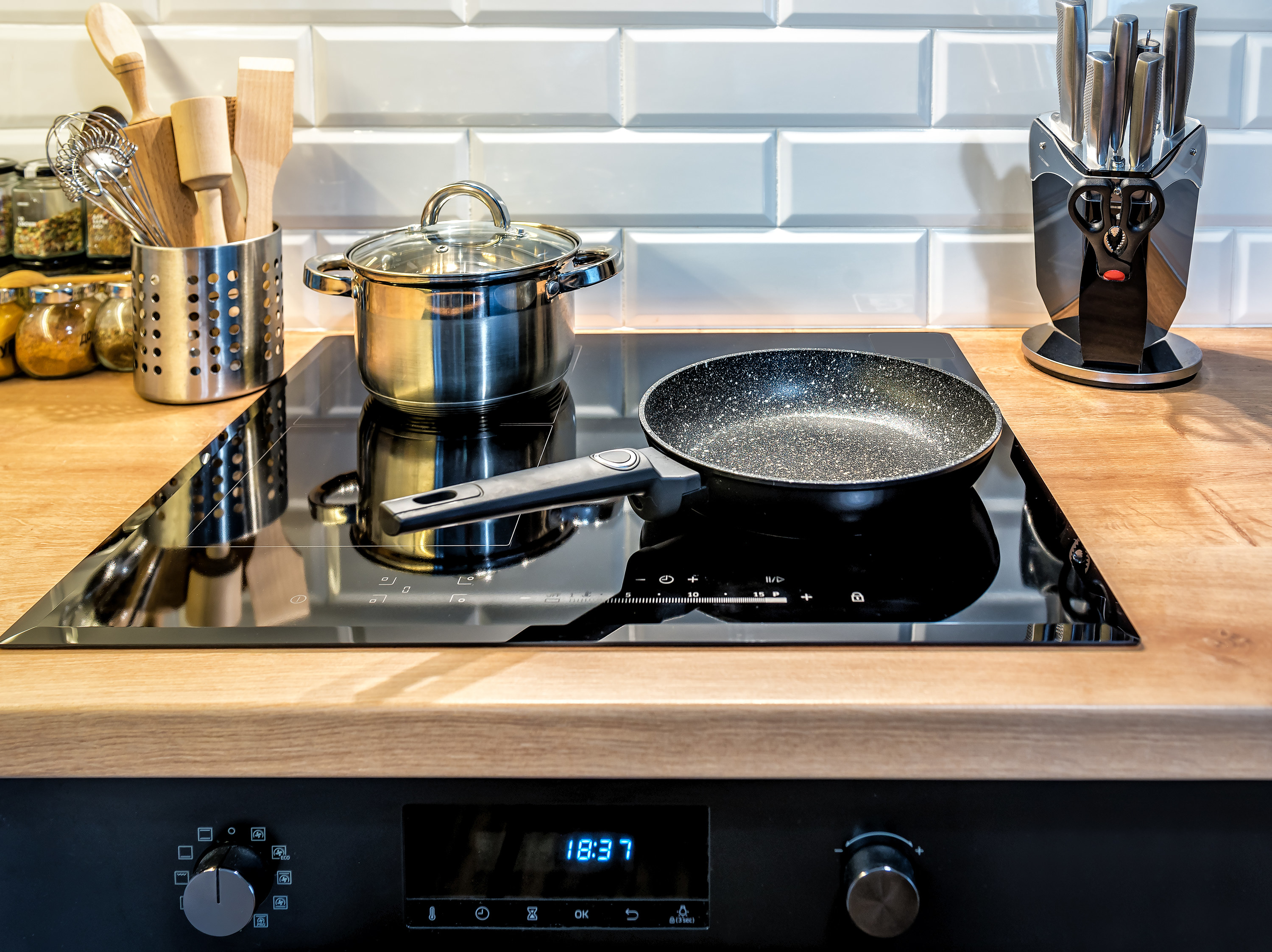 induction stovetop with various cookware on top