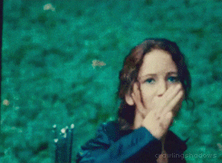 Katniss lifting three fingers