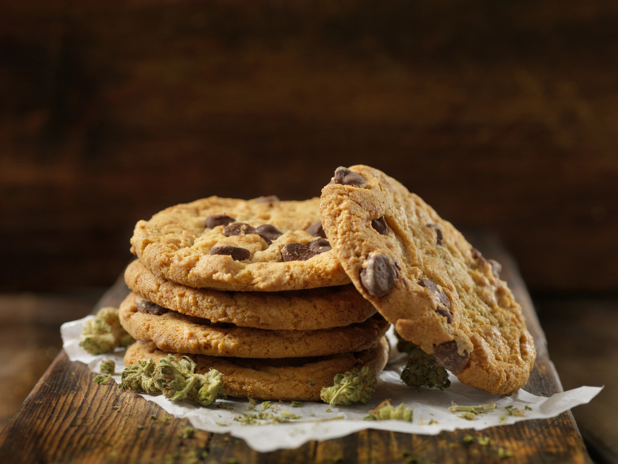 A stack of cookies with marijuana buds around them