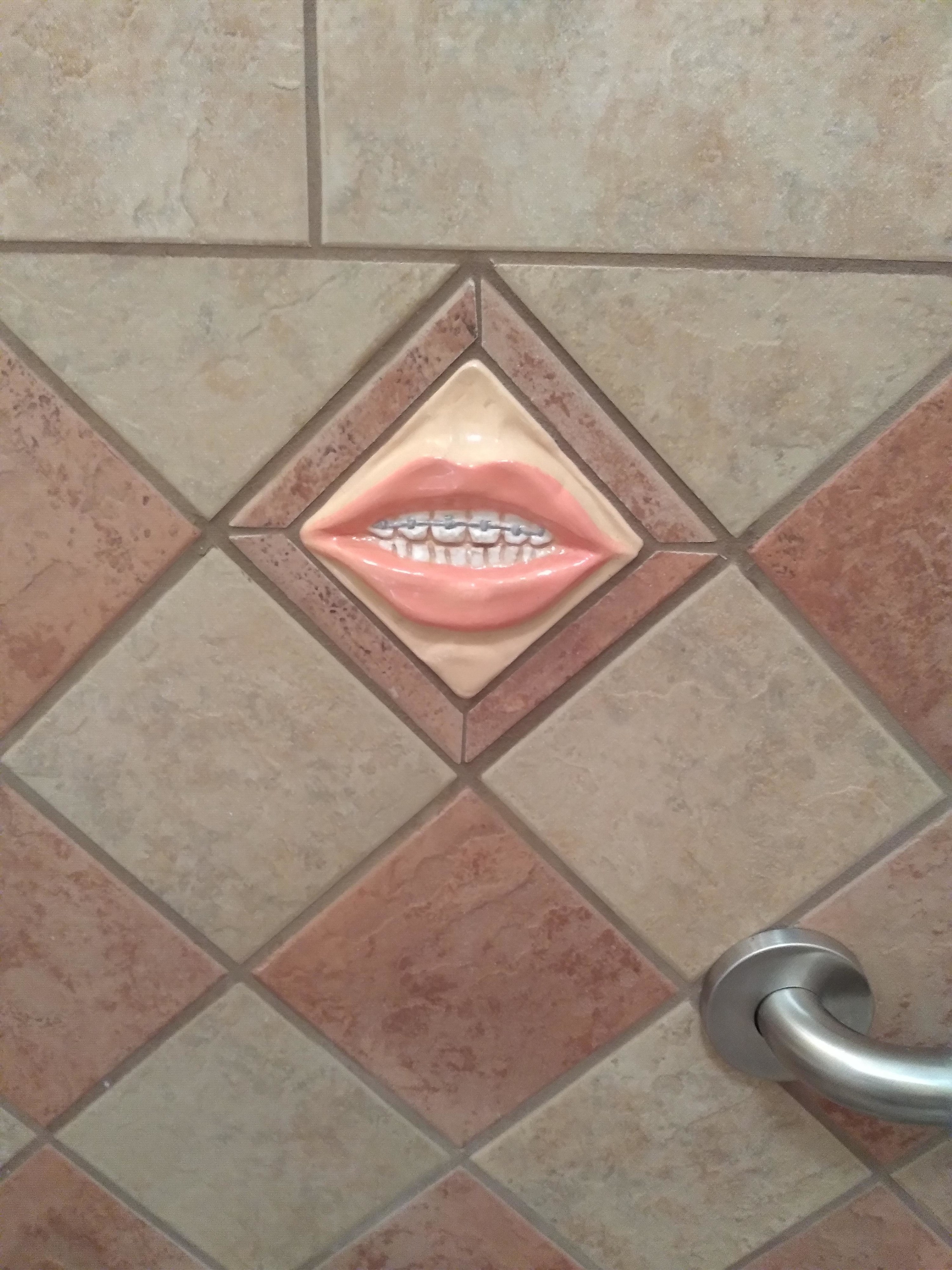 Tile in a bathroom with teeth
