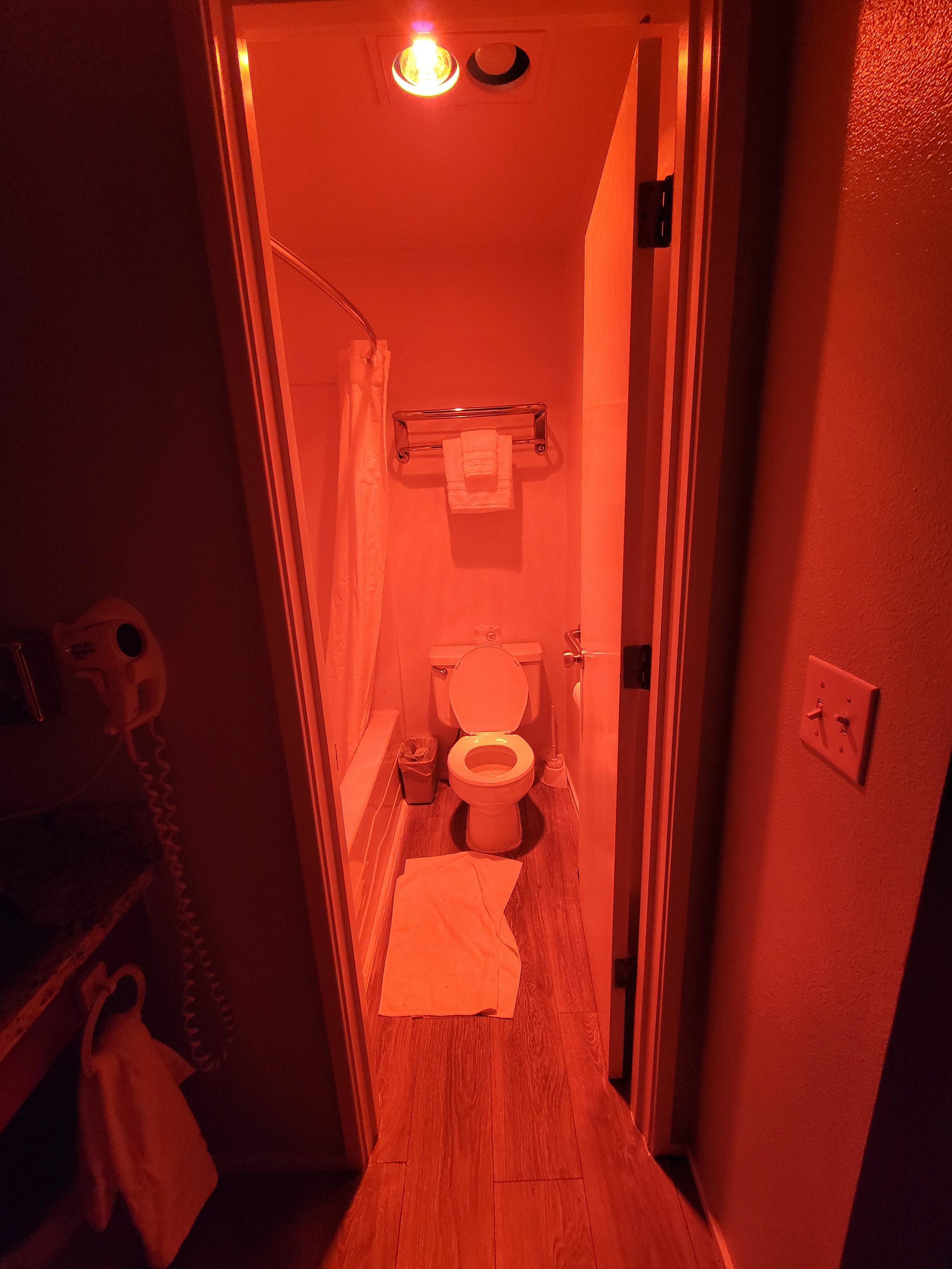 A bathroom lit up with red light
