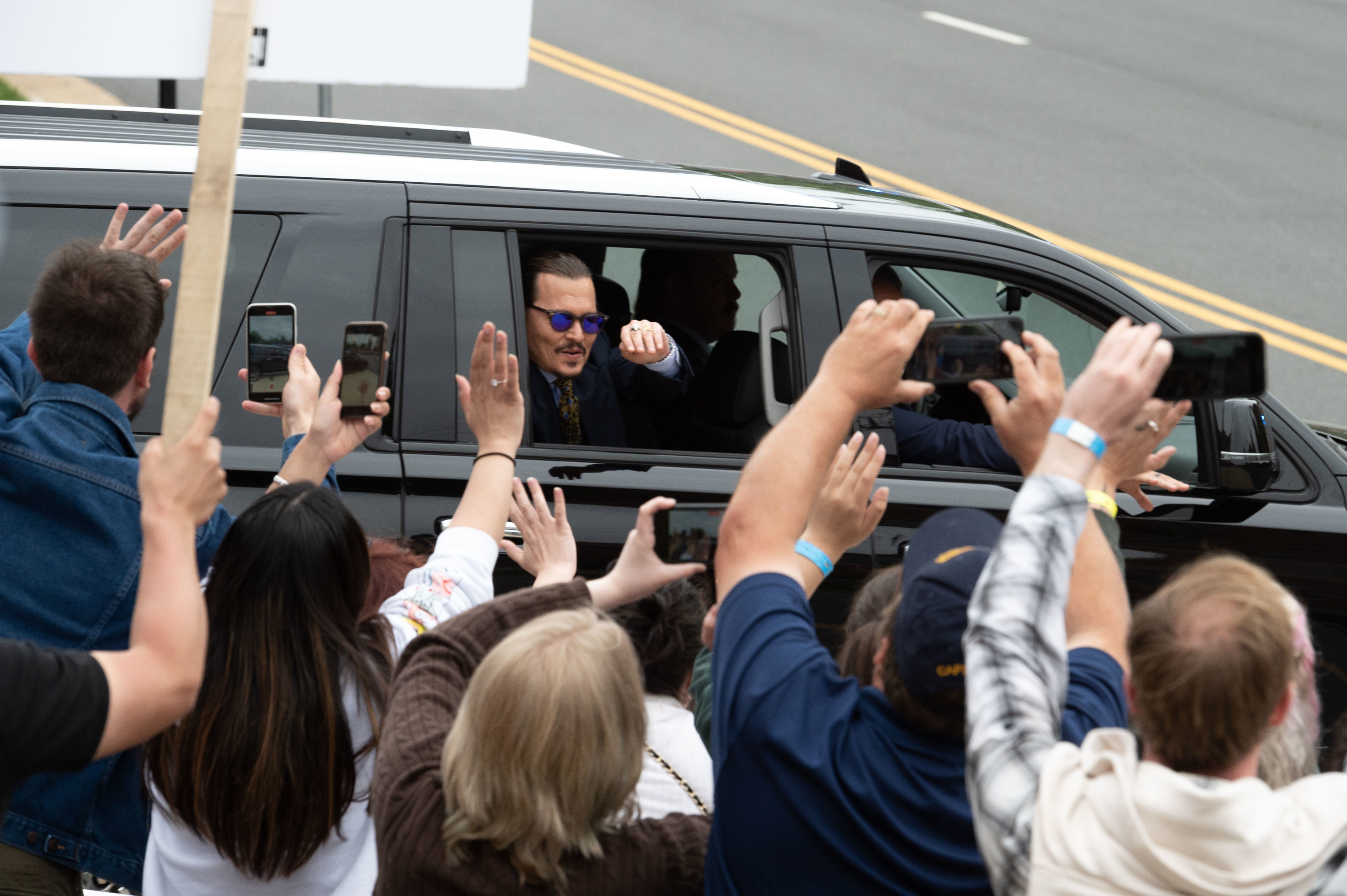 fans waving as depp drives away