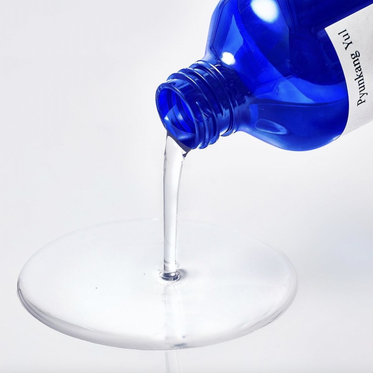 A bottle of toner being poured out