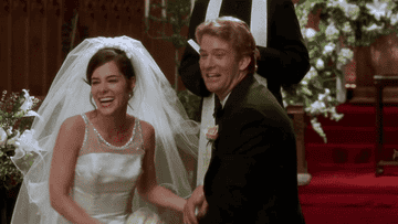 A bride and groom at the altar happily announcing that they're not getting married after all