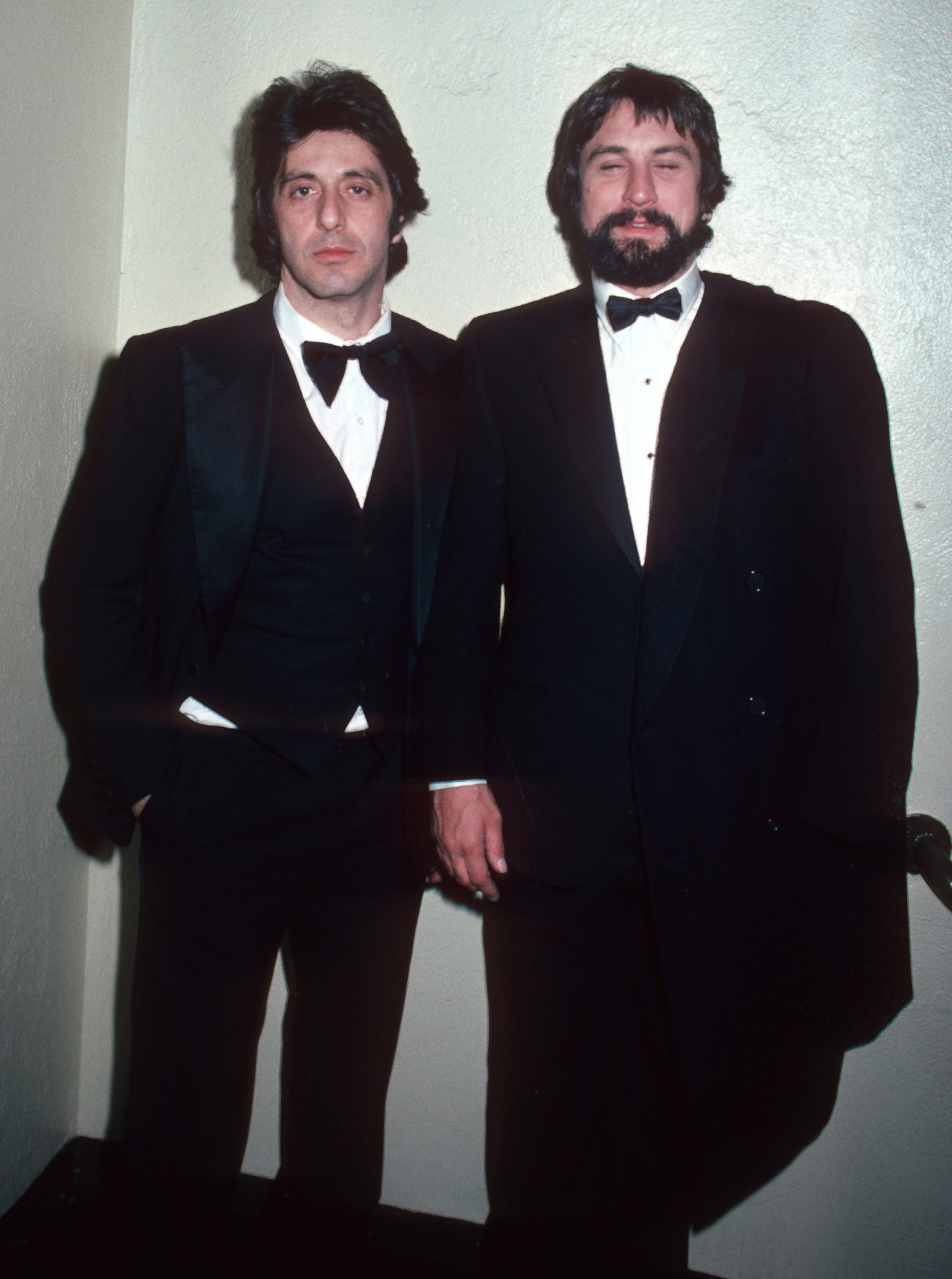 Pacino and De Niro in their younger days, both wearing bow ties