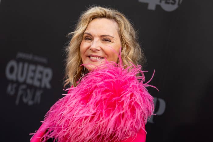 Kim Cattrall smiling in a feathery outfit