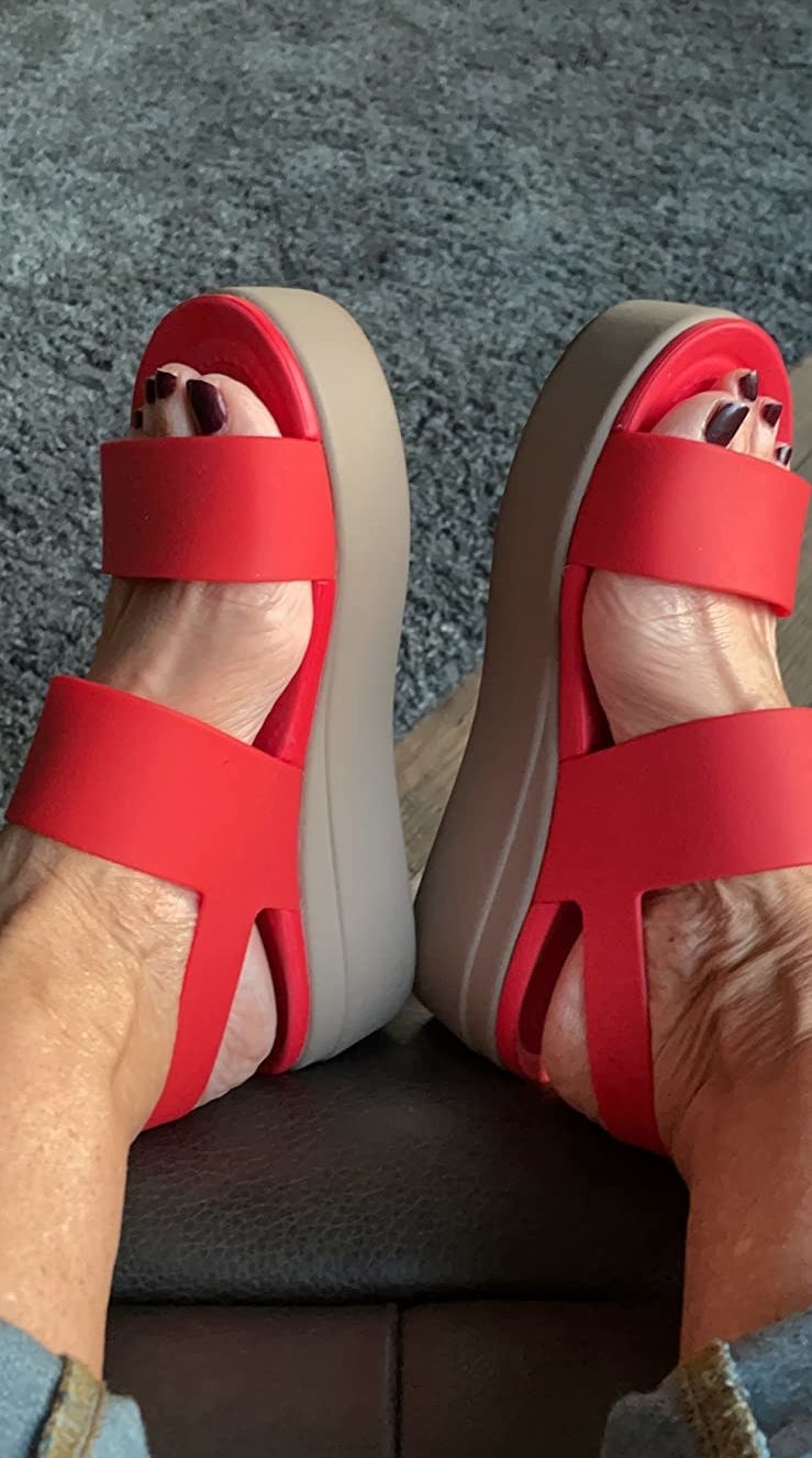 A reviewer wearing red sandals