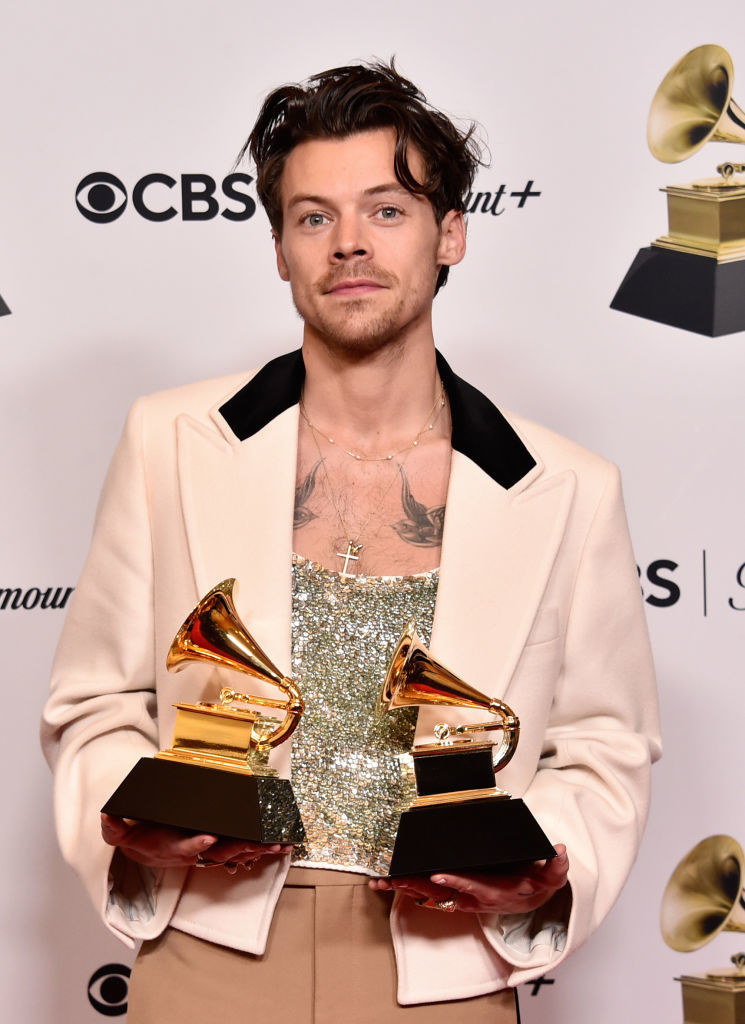 harry holding two awards