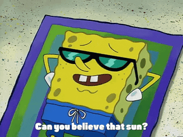 SpongeBob SquarePants laying on a towel in the sand while wearing sunglasses and saying &quot;Can you believe that sun?&quot;