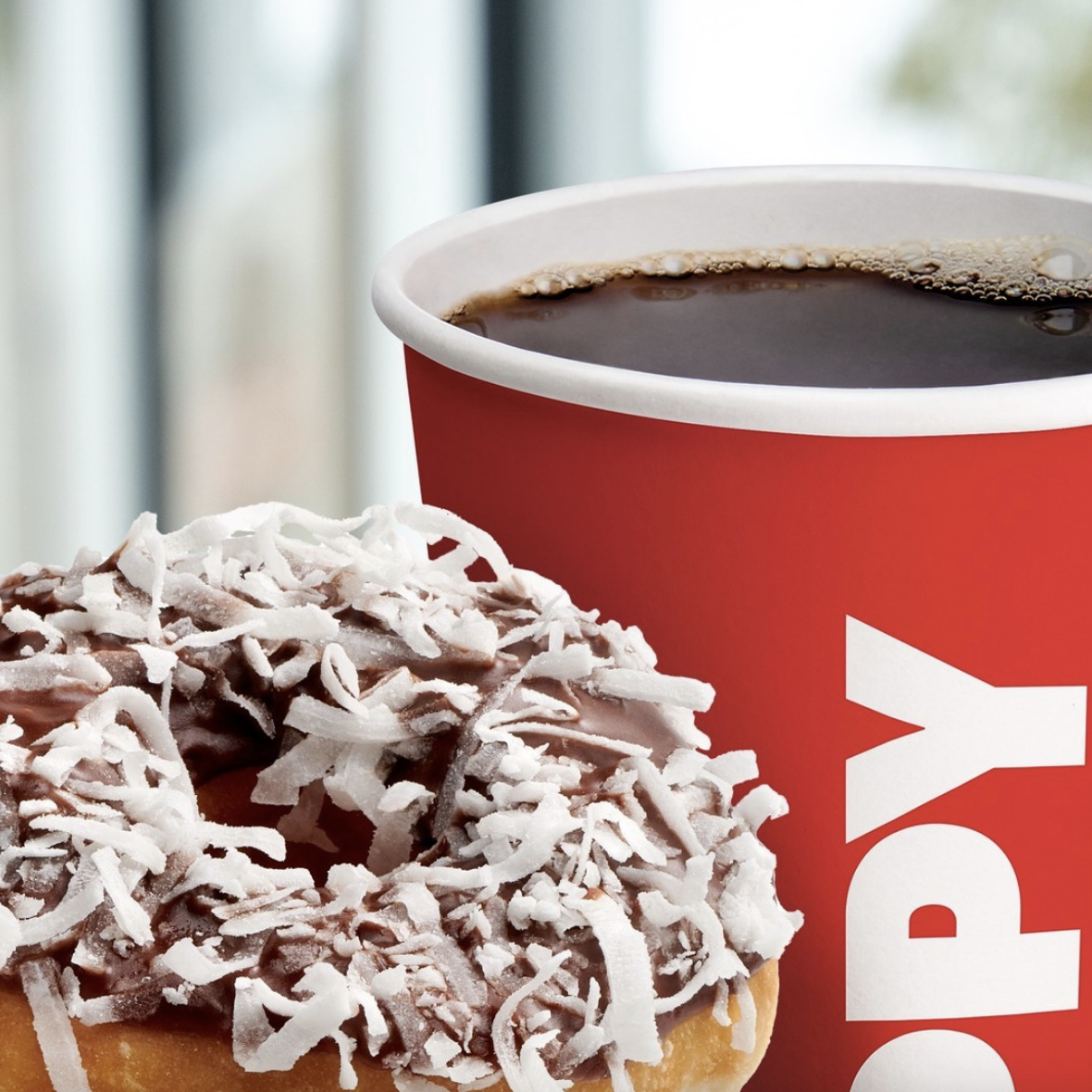 an up-close shot of a donut and coffee