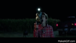 A young boy screams as he records something terrifying on a handheld crank camera