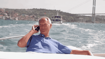 Person taking a phone call on a yacht
