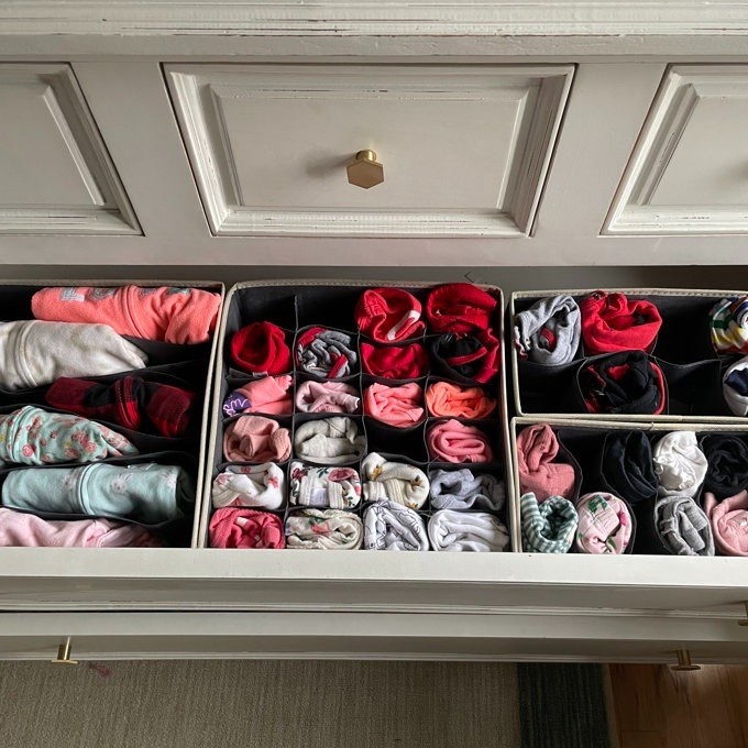 drawer organizer in drawer with clothes folded in them