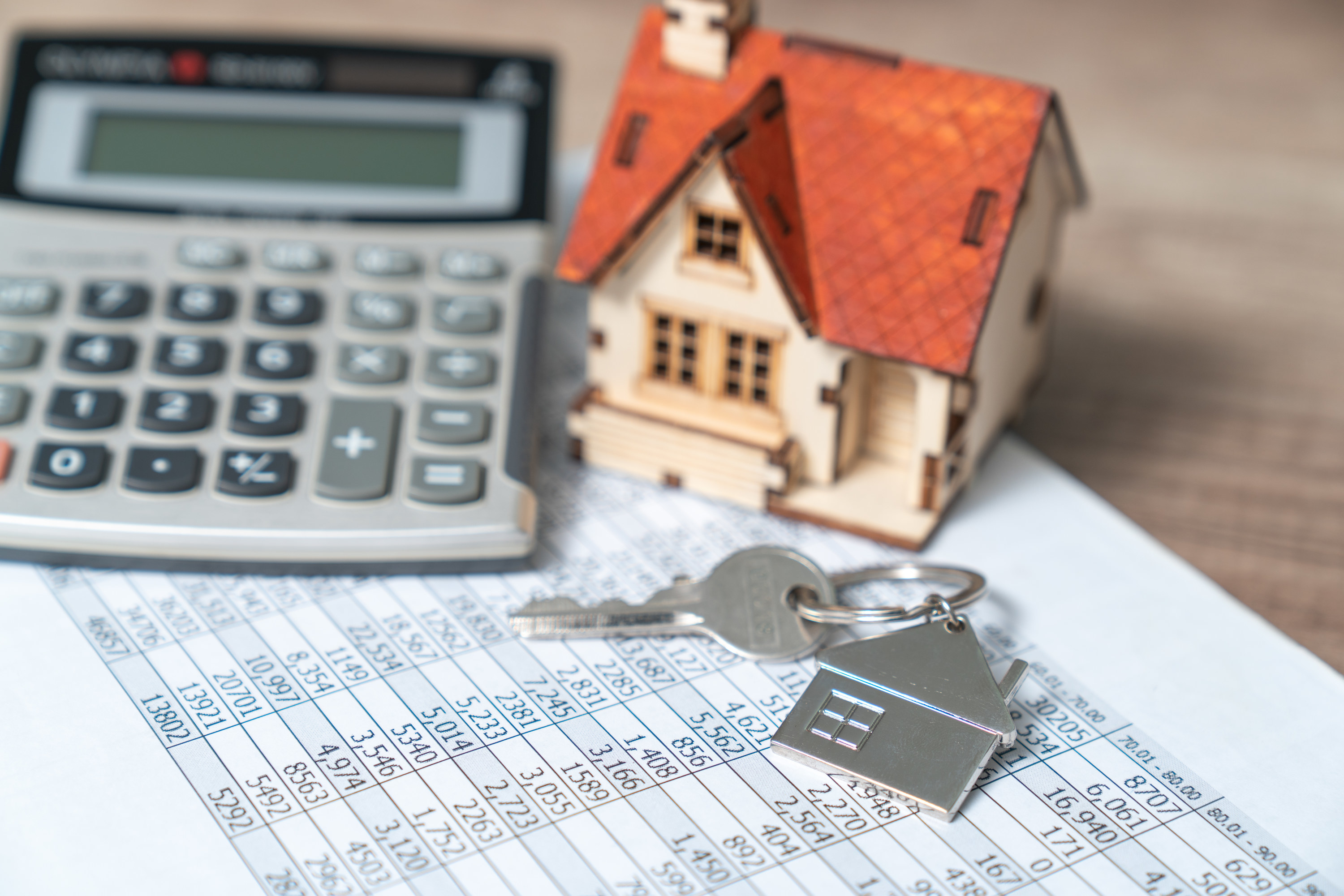 House keys and calculator on top of a spreadsheet showing mortgage rates
