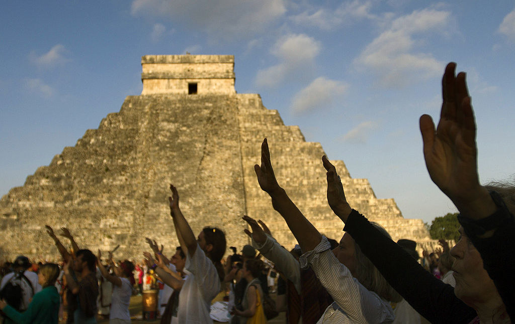 Visitors raise their hands during celebrations for the end of the Mayan cycle known as Bak'tun