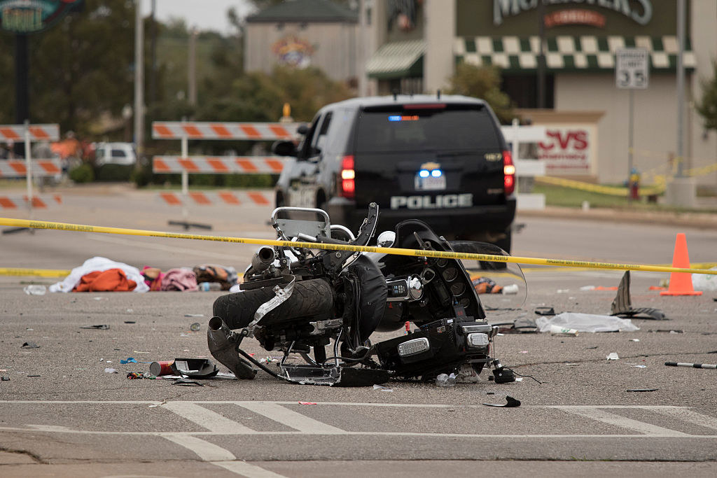 a crashed motorcycle and a police tape line