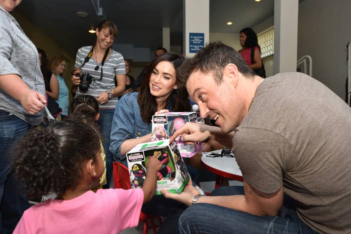 brian and megan giving toys to kids