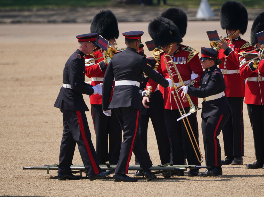 Medics coming to aid a trombonist for the Band of the Welsh Guards