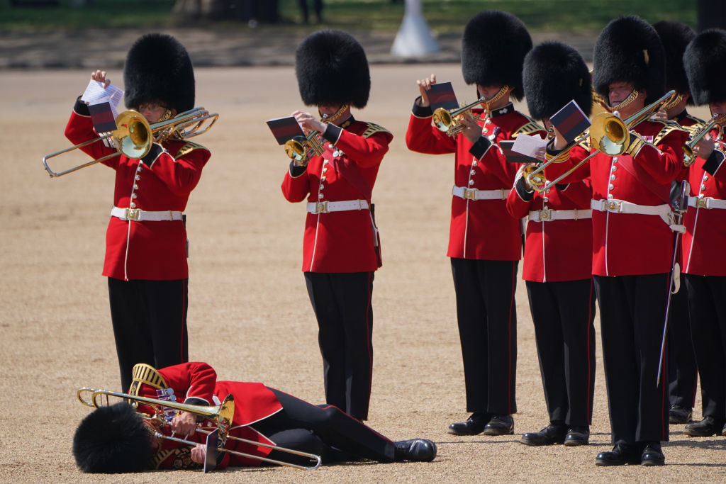 A trombonist for Band of the Welsh Guards fainted and laying on the ground