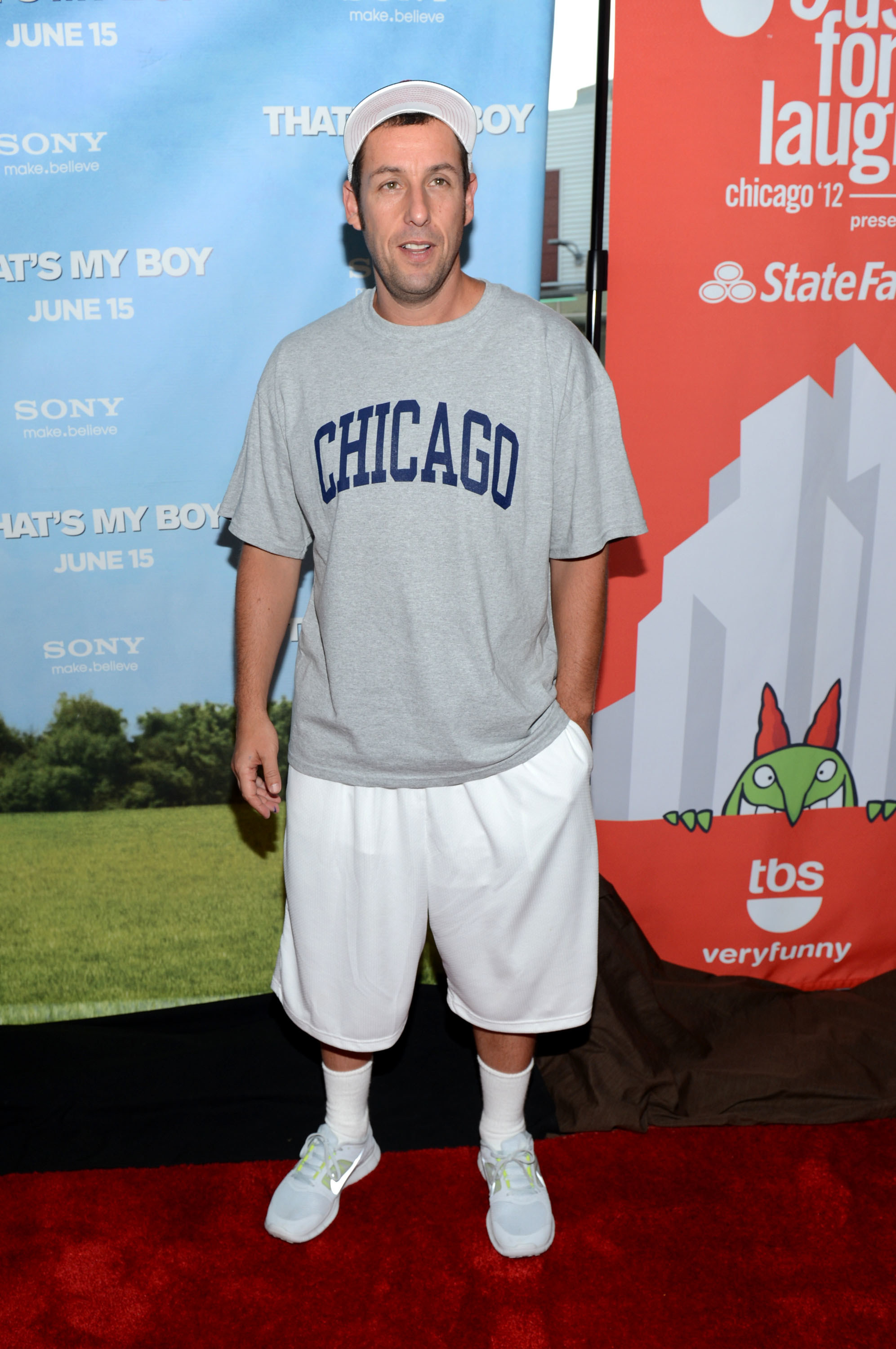 The shorts and long and baggy, the T-shirt is a Chicago tee, and he&#x27;s wearing a cap
