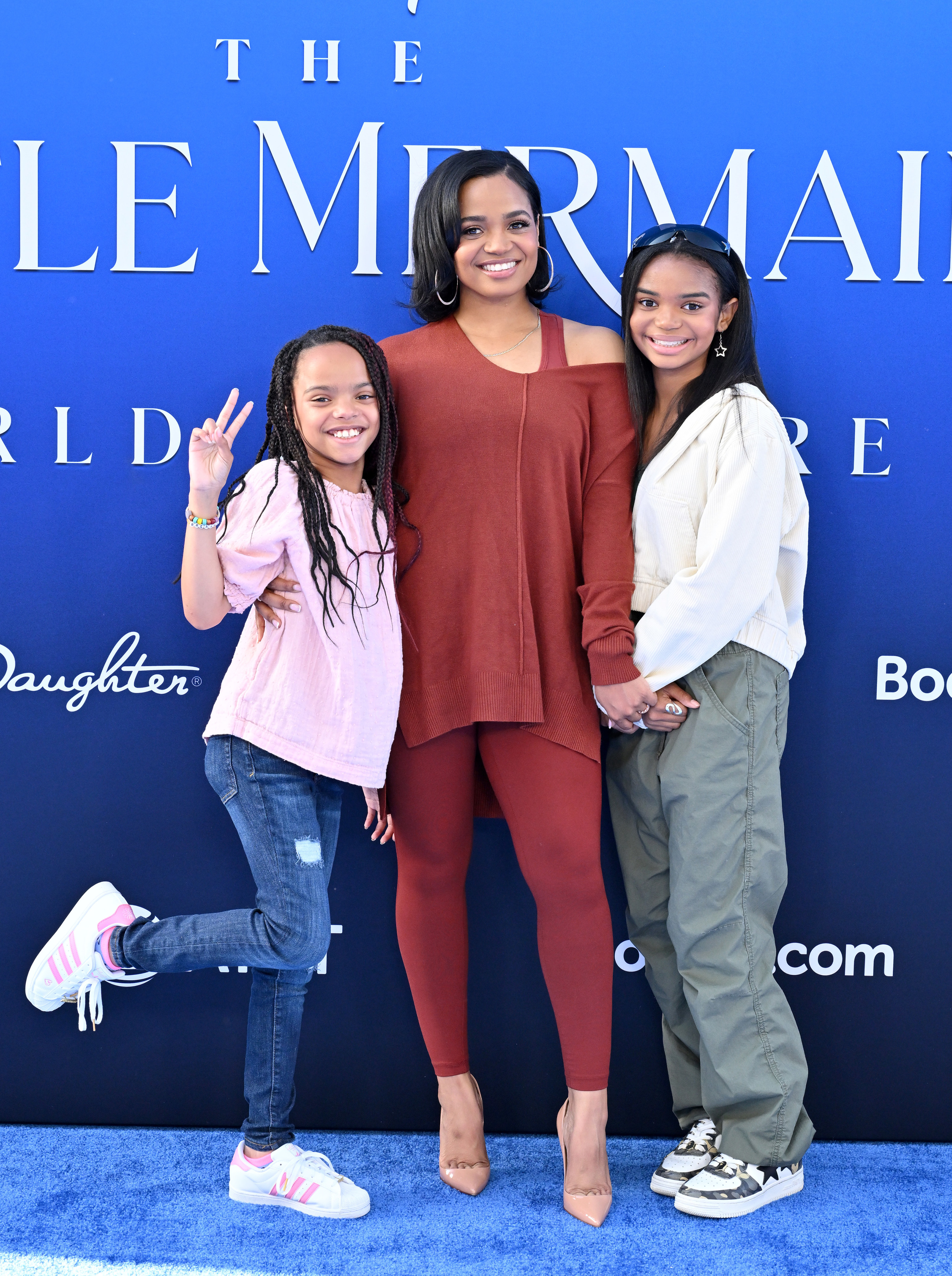 Kyla in the outfit with two young girls