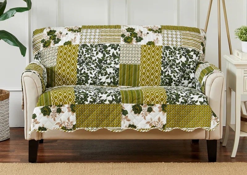 the cover in olive on a loveseat