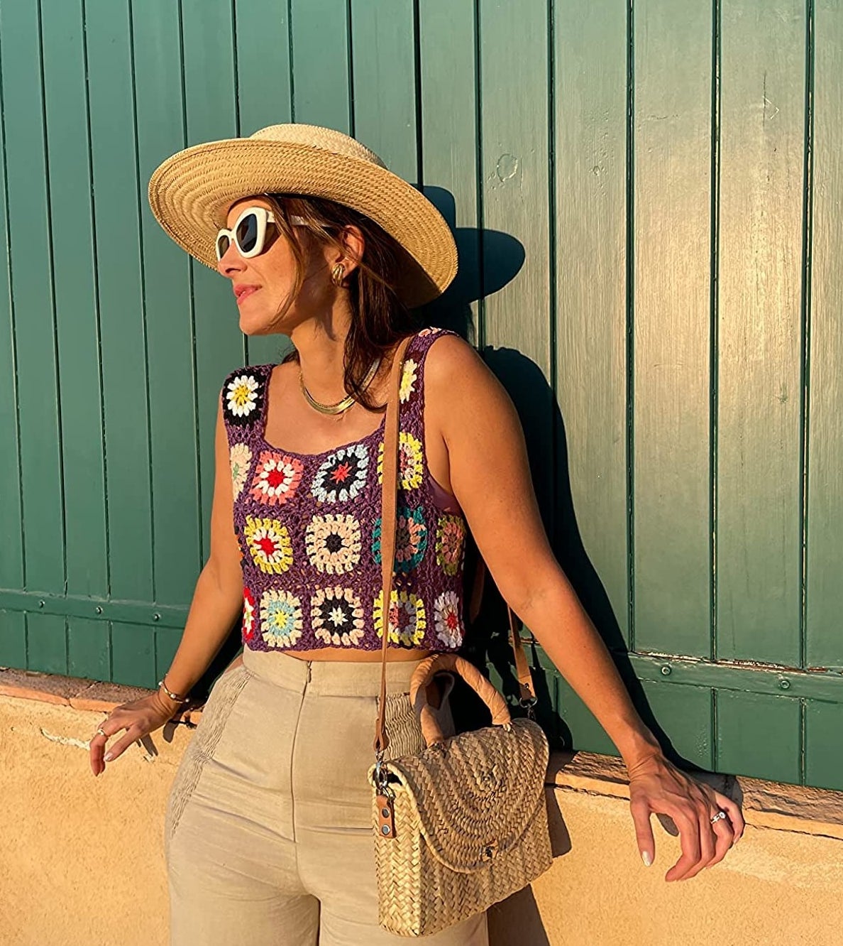 Reviewer wearing the purple and multicolored granny square crochet top