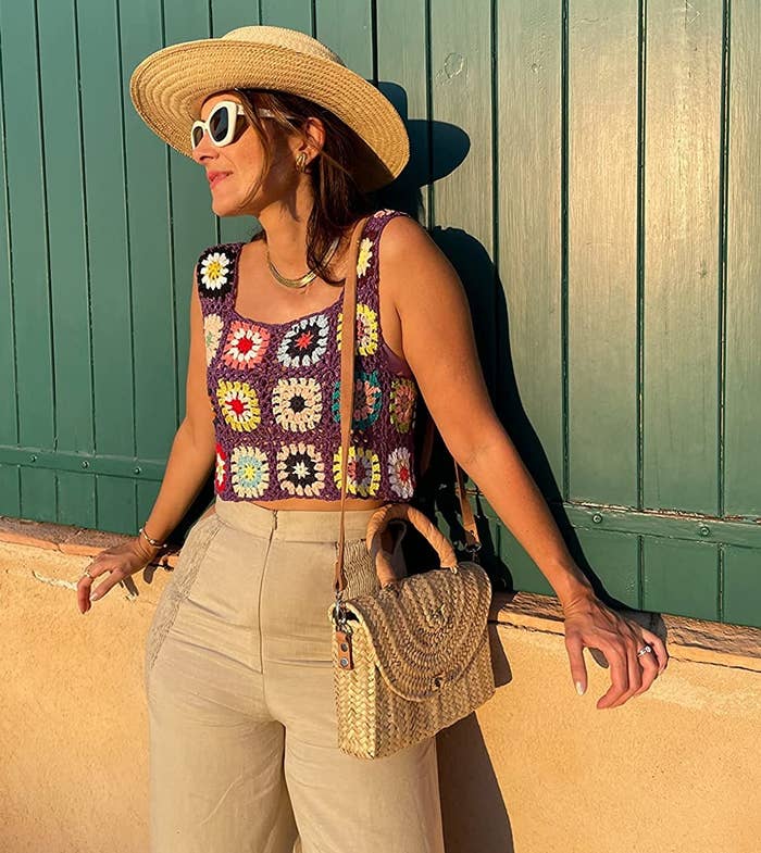 Reviewer wearing the purple and multicolored granny square crochet top