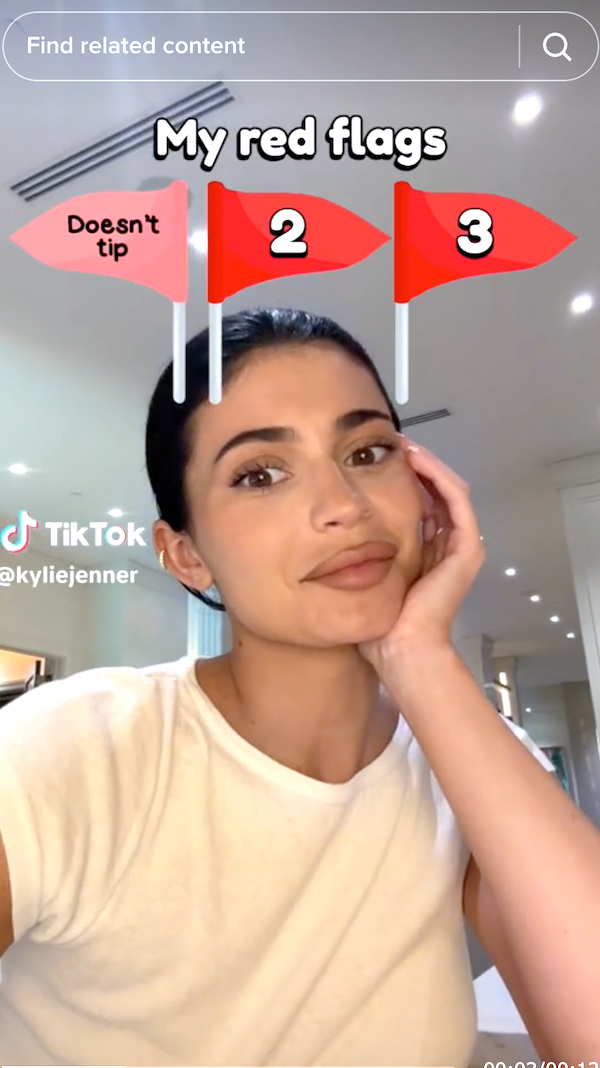 Closeup of Kylie Jenner with a red flag saying, &quot;doesn&#x27;t tip&quot;