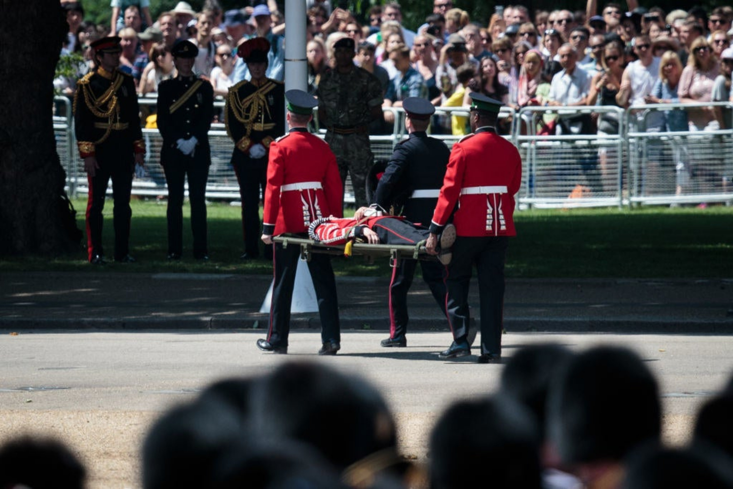 A member of the Coldstream Guards being taken away on a stretcher
