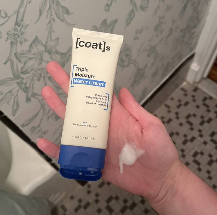 The [coat]s triple moisture water cream in its packaging next to a swatch of the product