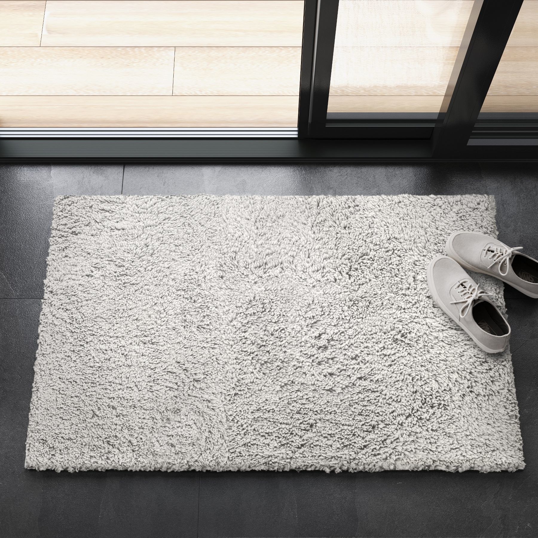 A gray rug with shoes on top