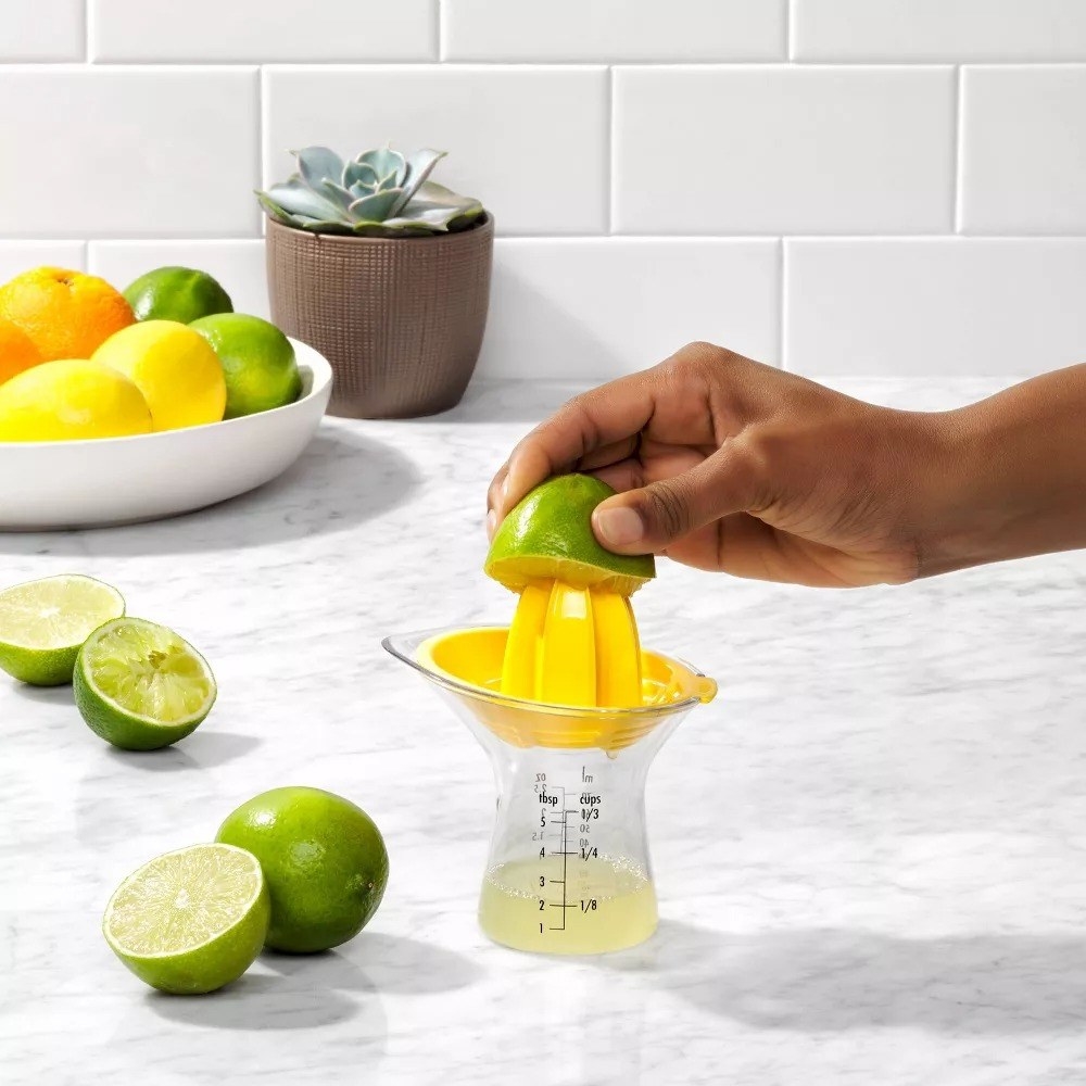 a model using the reamer to juice a lime
