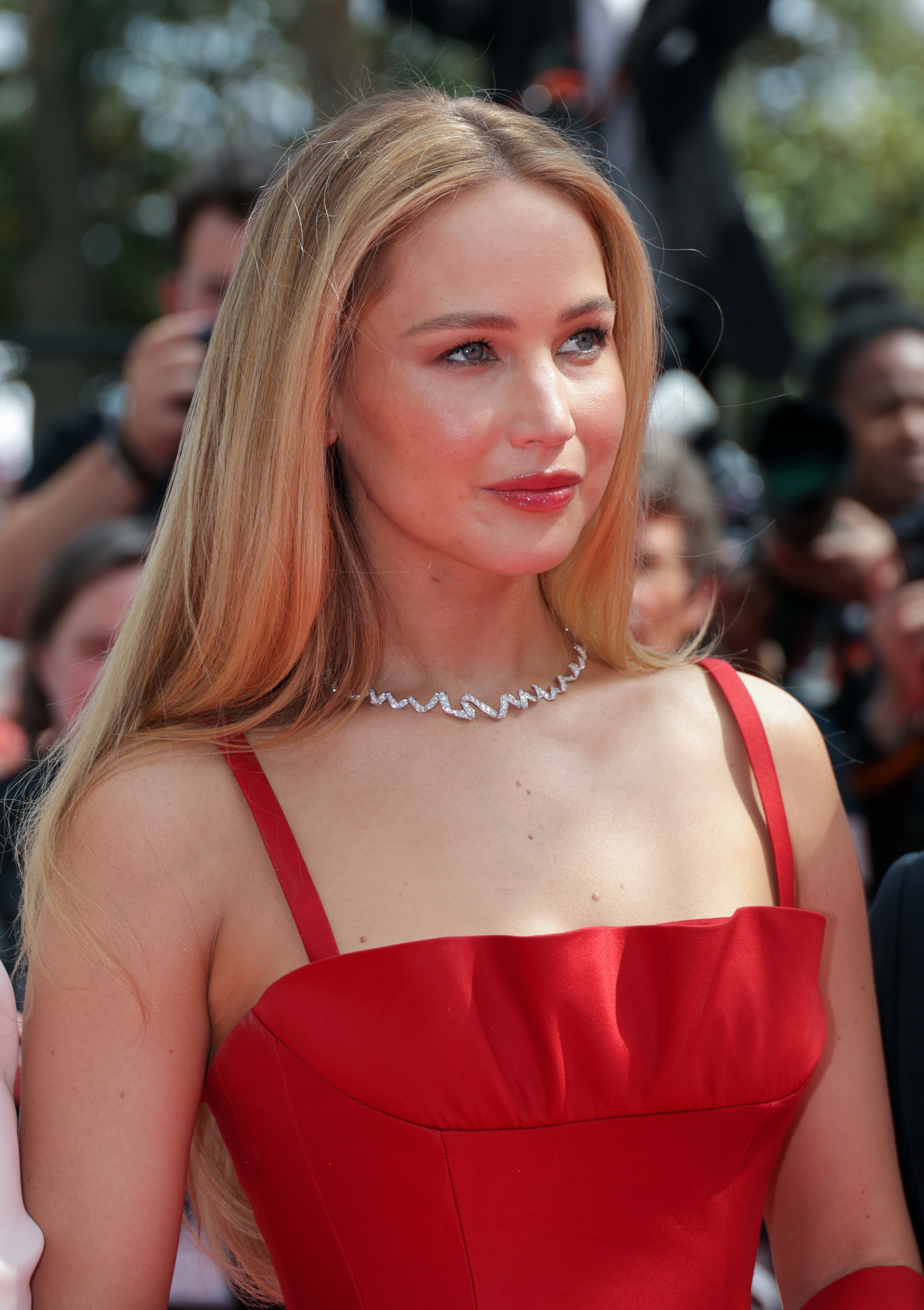 Close-up of JLaw in a spaghetti-strap outfit and choker