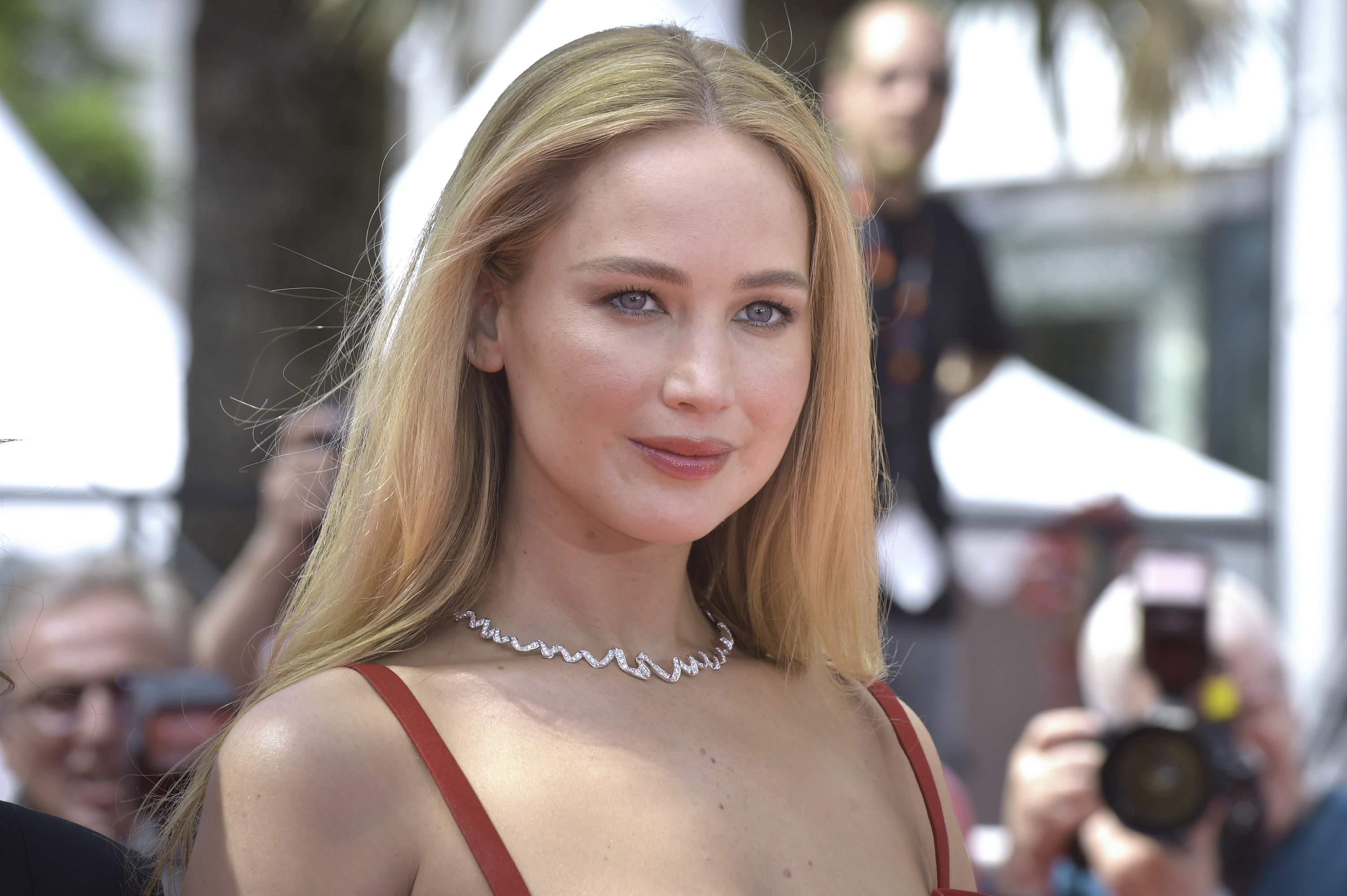 Close-up of JLaw in a spaghetti-strap outfit and choker