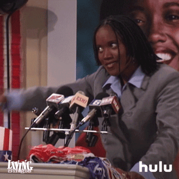 gif of a character from Living Single speaking behind a campaign podium