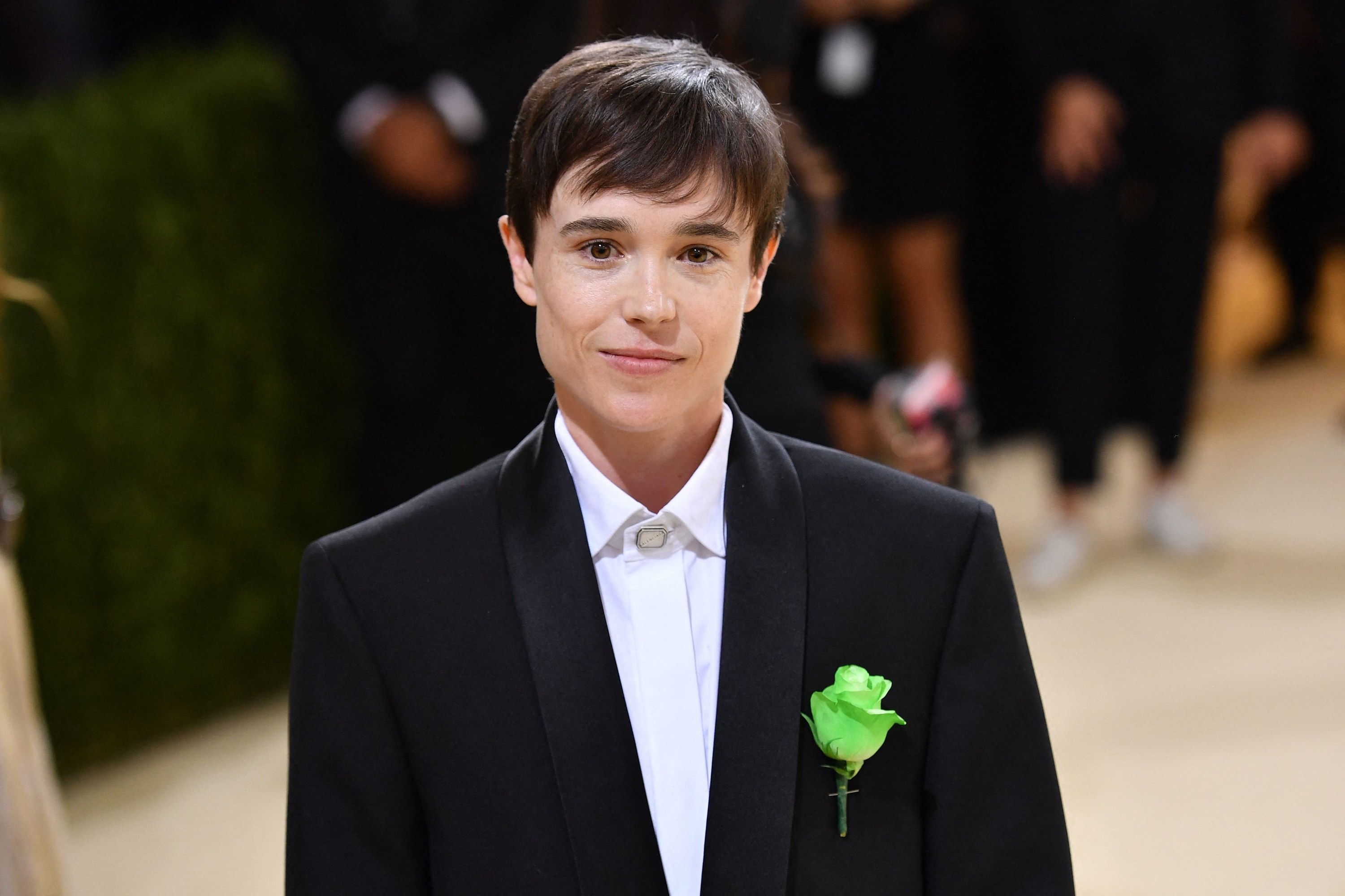 Close-up of Elliot in a shirt and suit jacket with a corsage