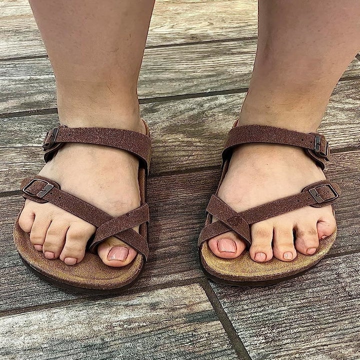A reviewer's photo of the sandals in brown