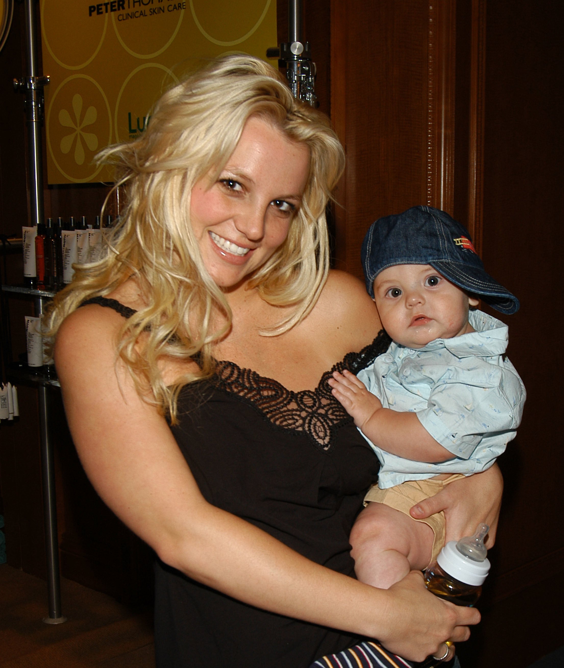 Britney holding one of her baby boys and a baby bottle