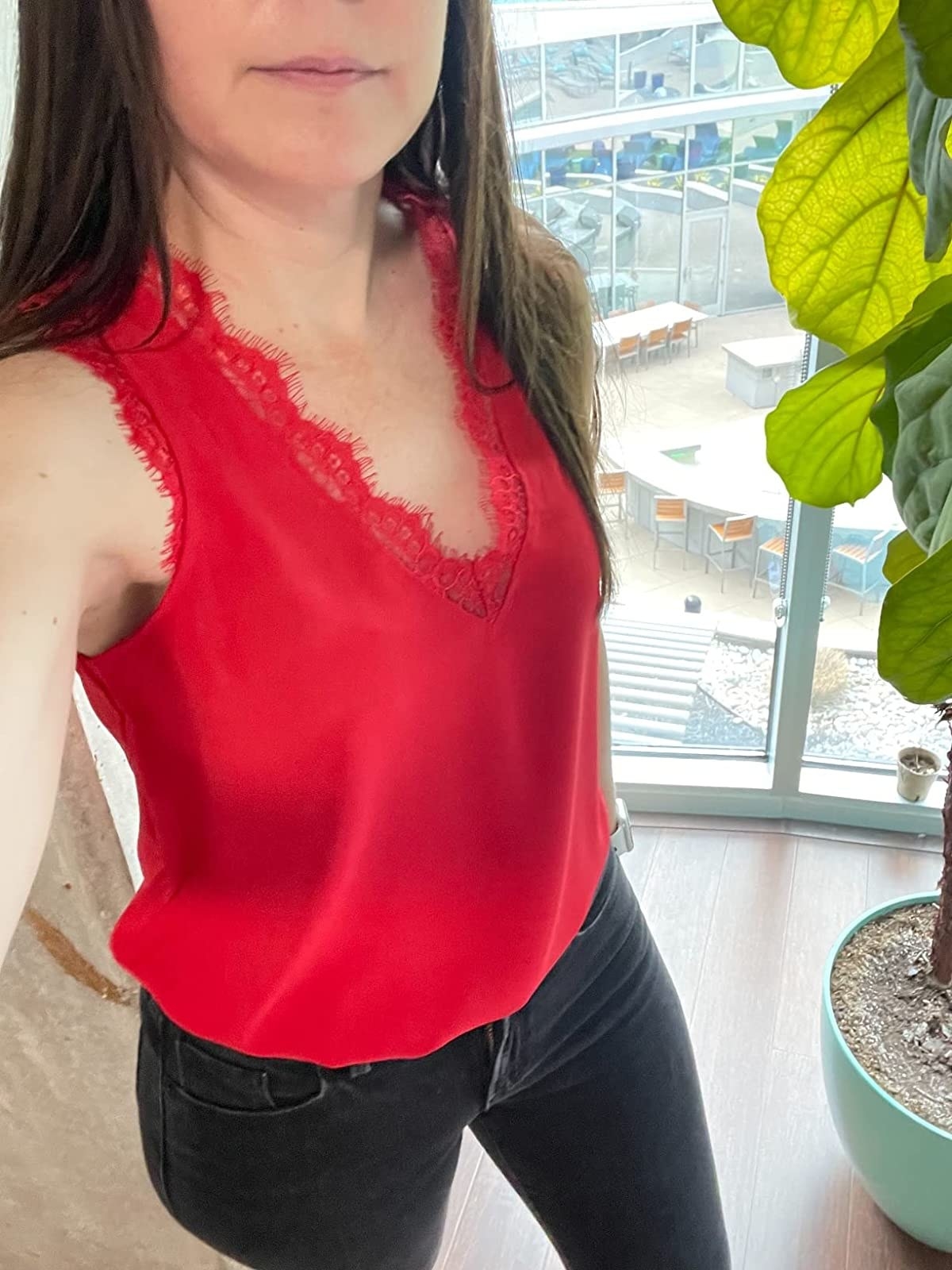 a reviewer wearing a red tank top with jeans