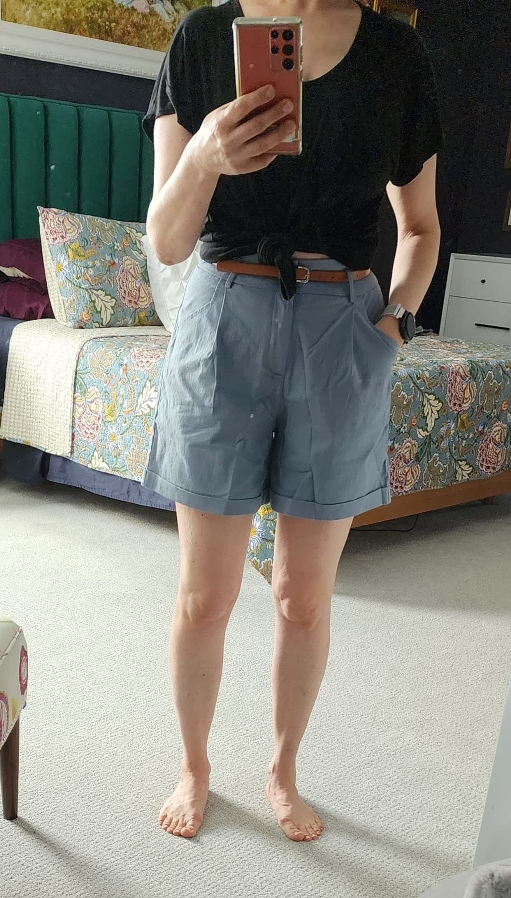 A reviewer wearing the grey trouser shorts
